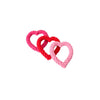 Three heart-shaped rope dog toys in magenta, red, and pink.
